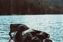 BAMWOO bamboo toothbrush in a washbag next to a lake, on a camping and hiking trip in Austria