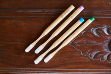 Four bamboo toothbrushes in different colours