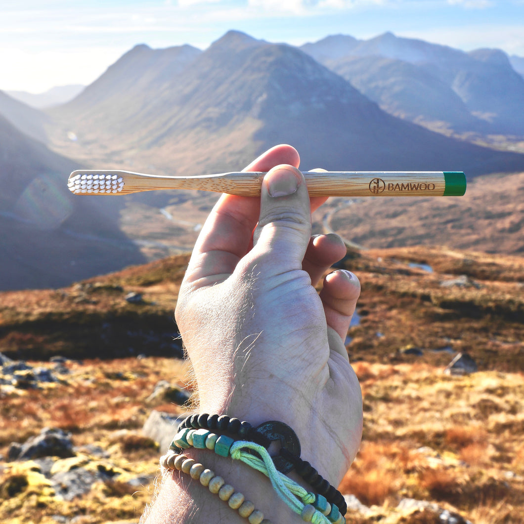 Holding a bamboo toothbrush in Glen Coe, Scotland