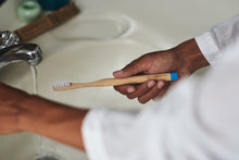 Brushing teeth with a BAMWOO bamboo toothbrush