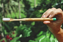 A BAMWOO bamboo toothbrush in the jungle in Ubud, Bali