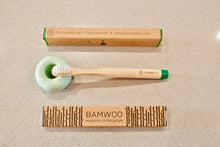 BAMWOO children's bamboo toothbrush in forest green with green ceramic toothbrush holder