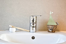 Children's bamboo toothbrush in natural from BAMWOO on sink in bathroom